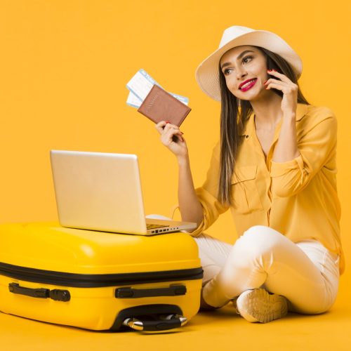 smiley-woman-posing-luggage-while-holding-plane-tickets-passport